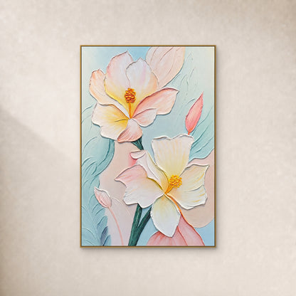 Two cream and blush flowers with raised yellow centres on pale aqua, in a thin gold frame against an ivory wall