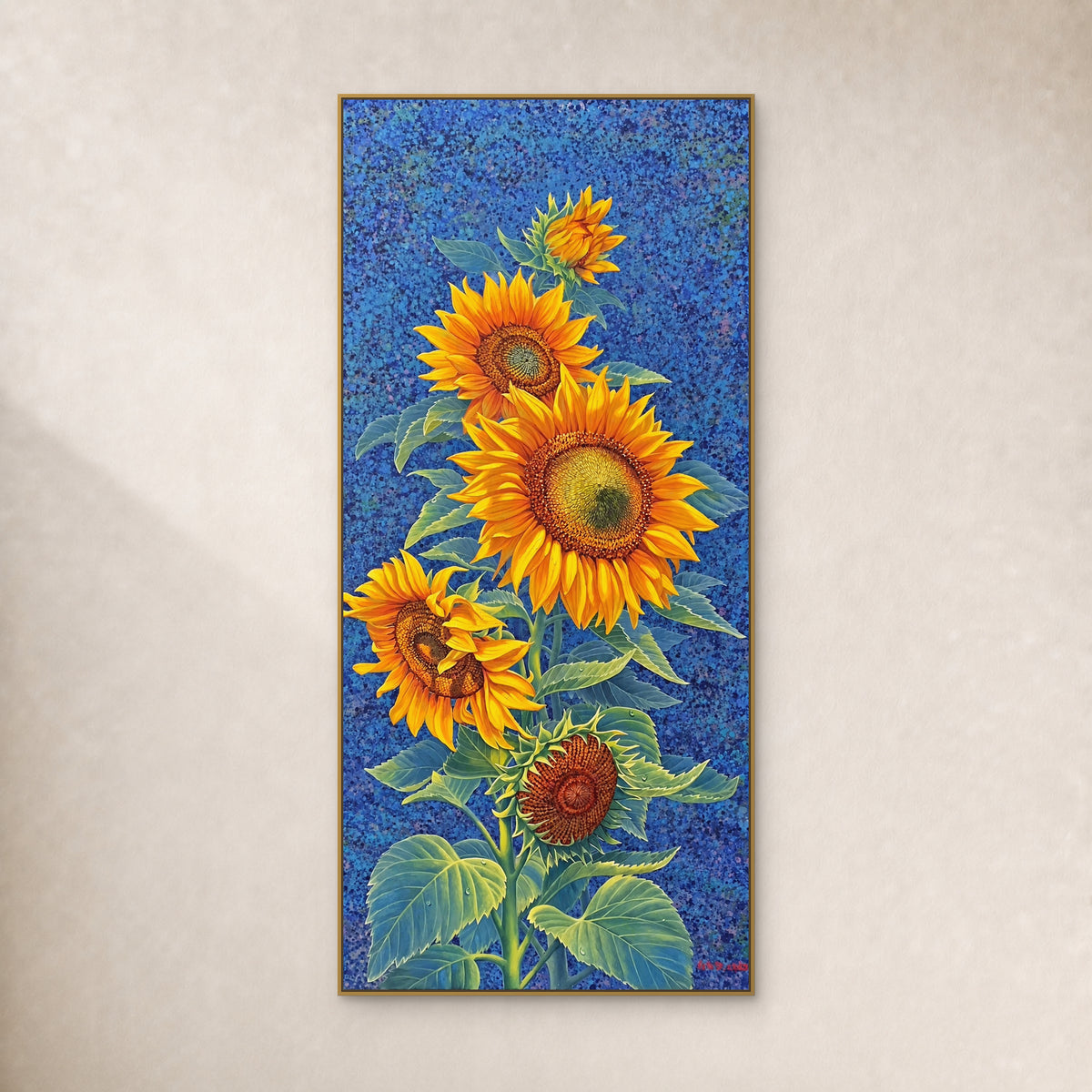 Tall yellow sunflower painting on a cobalt-blue ground in a slim gold-tone frame against an ivory wall