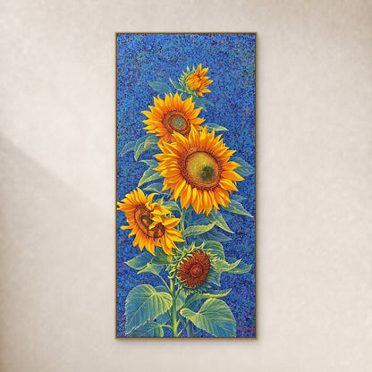 Tall yellow sunflower painting on a cobalt-blue ground in a slim gold-tone frame against an ivory wall