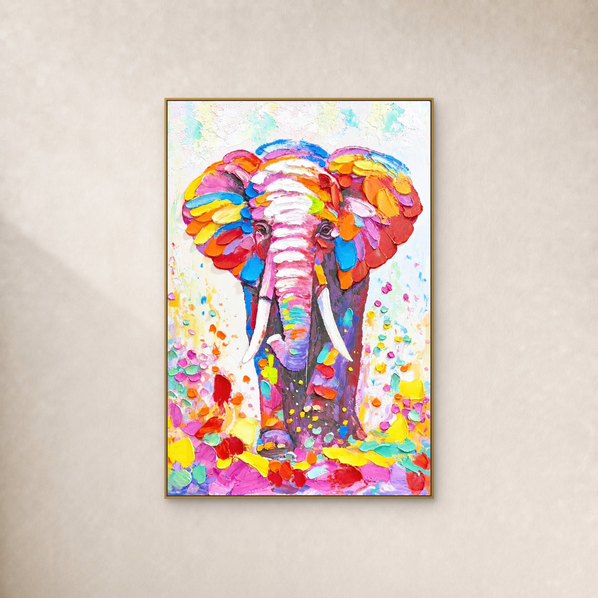 Colourful elephant portrait in a thin gold floating frame on an ivory wall