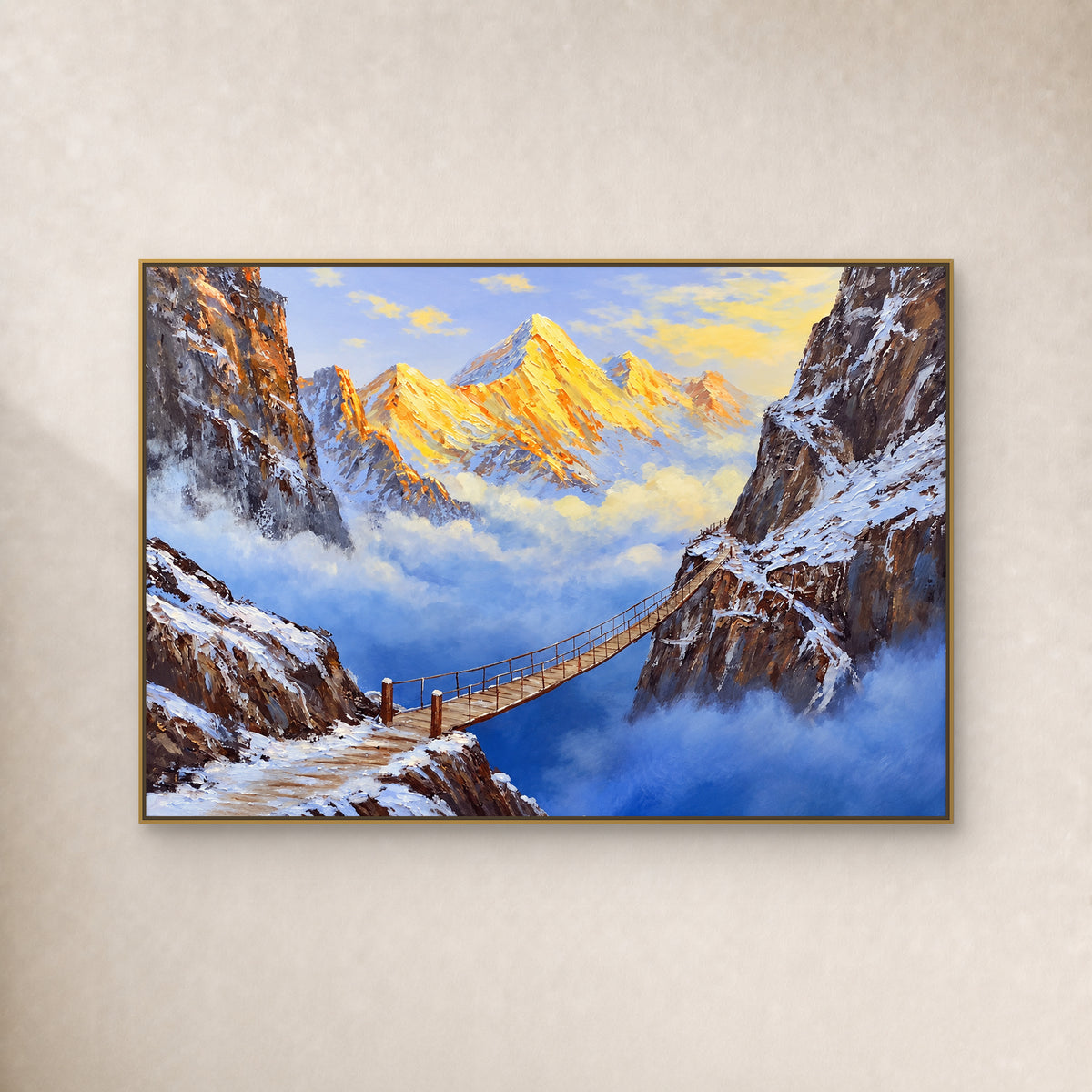 Golden mountain peaks and a suspension bridge over blue canyon mist, shown in a slim gold frame on an ivory wall