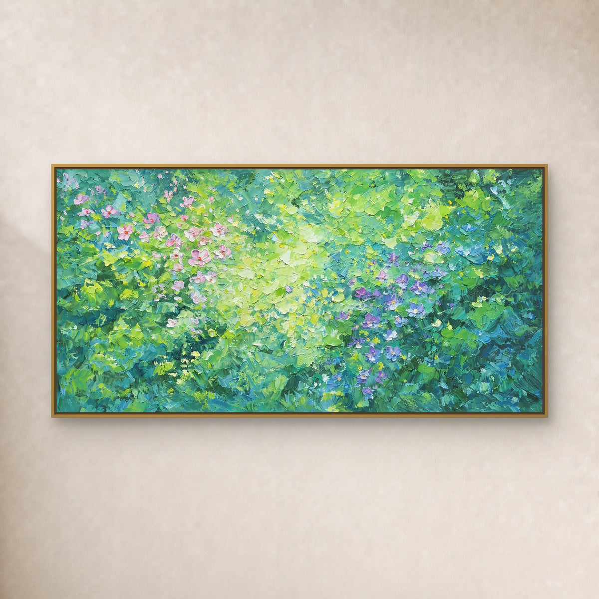Wide green floral painting with pink and violet blossoms in a thin gold-toned floating frame on a plain ivory wall