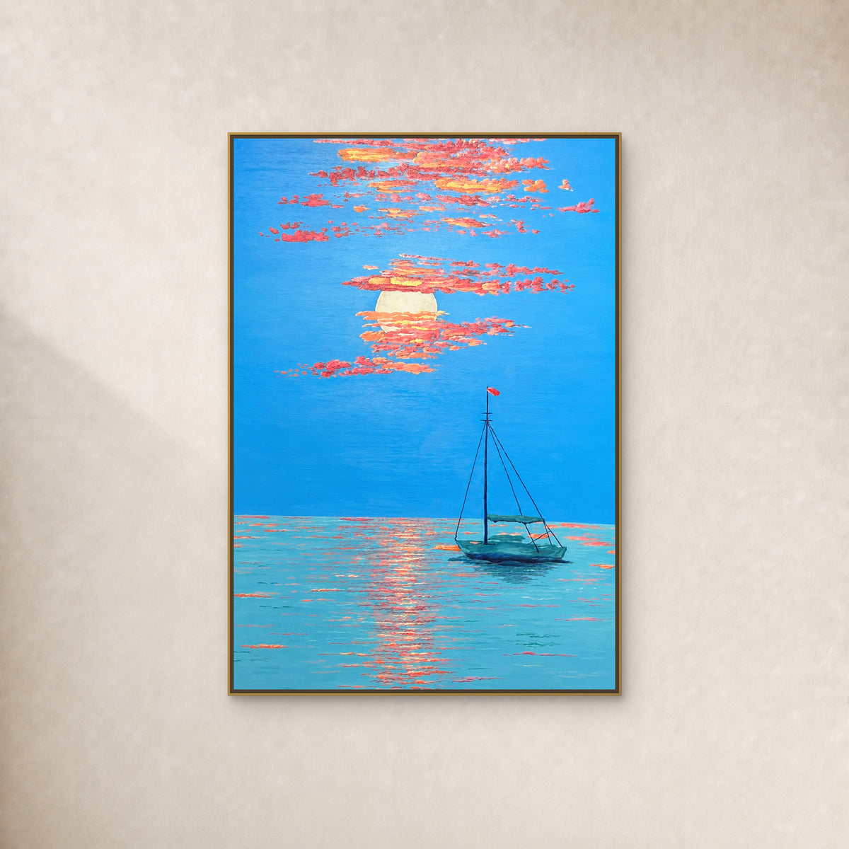Vertical blue seascape with a teal boat and coral sunset clouds in a thin gold floating frame on an ivory wall.