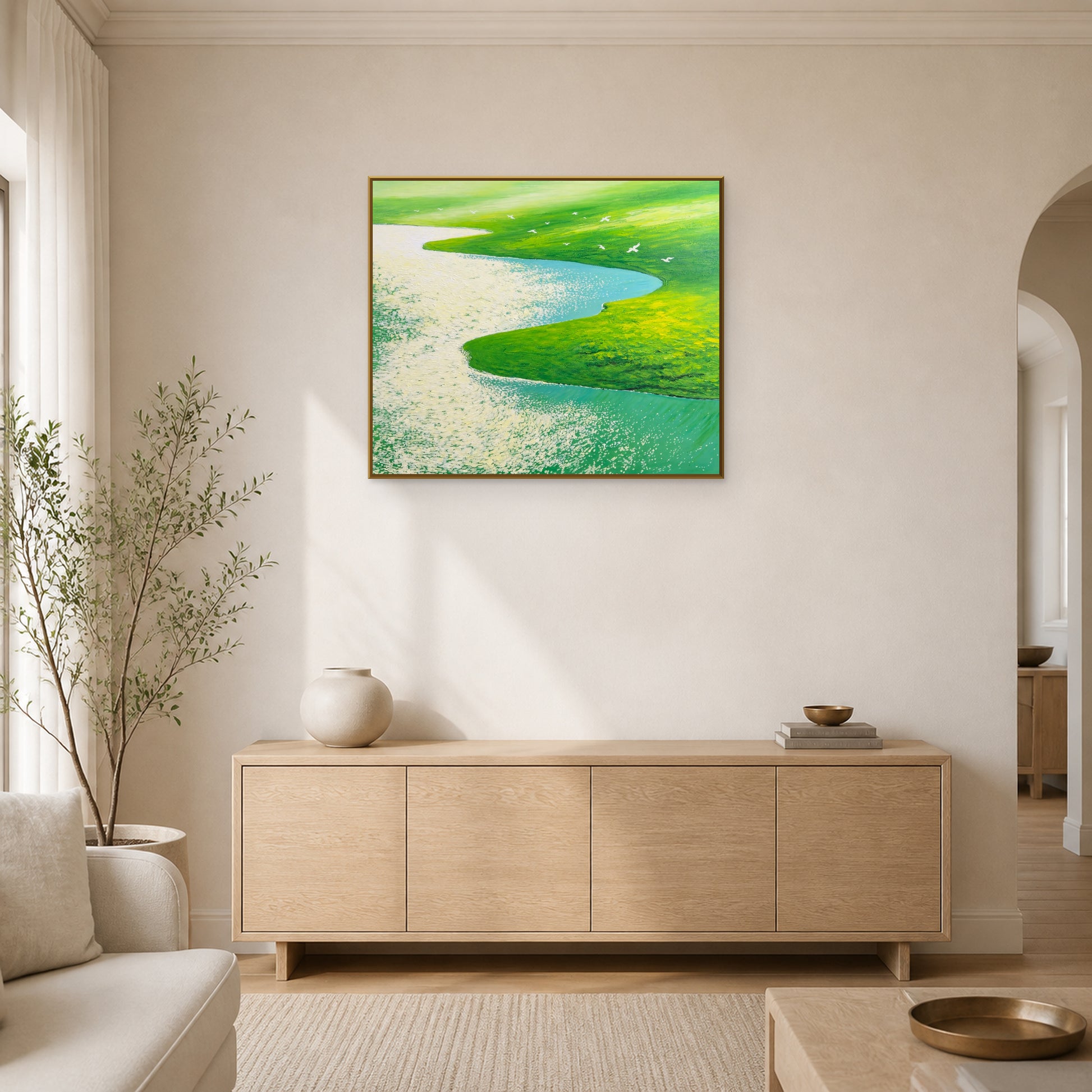 Flight Over Green Meadows in a slim brass floating frame above a pale oak living room sideboard