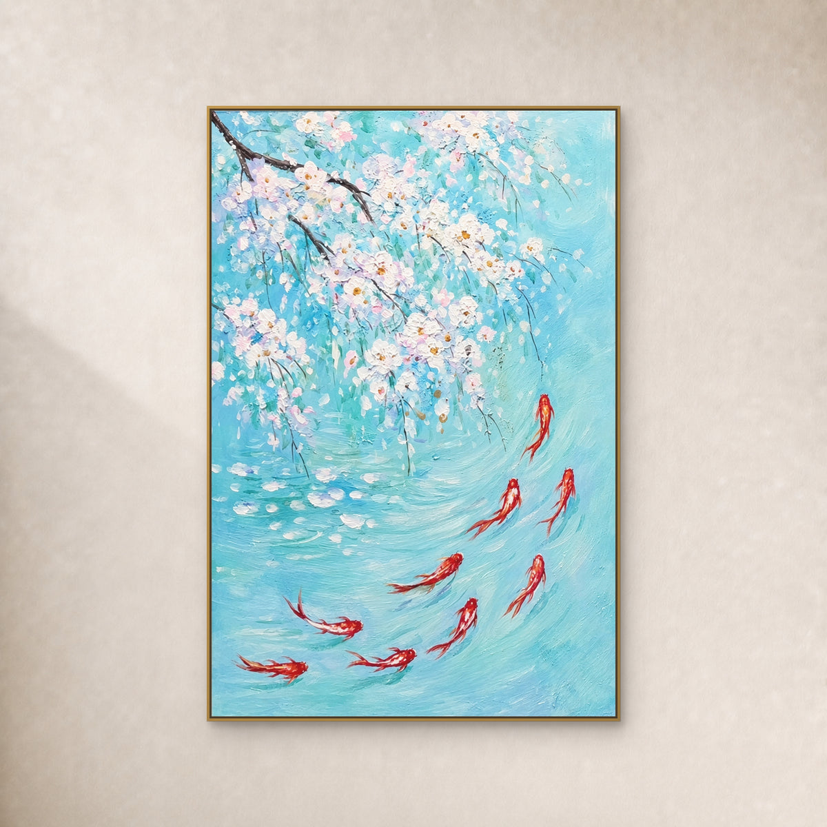 Nine red-and-white koi beneath white blossoms in turquoise water, in a slim gold-coloured floating frame on an ivory wall.