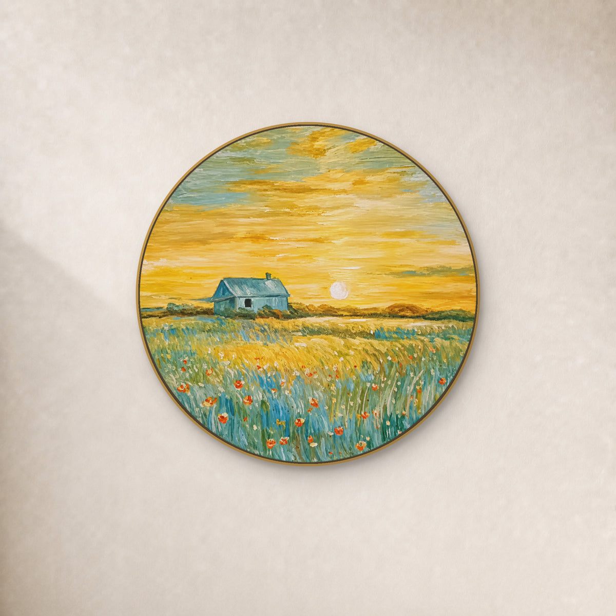 Round cottage and golden meadow painting in a thin gold-tone frame on an ivory wall