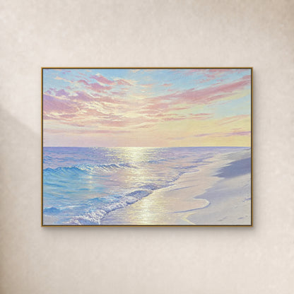 Pastel beach painting with pink clouds, blue surf and reflected light in a slim gold-tone frame on an ivory wall
