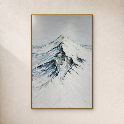 Snowcrest snowy mountain painting with ivory slopes and blue-grey shadows in a slim gold-tone frame on an ivory wall