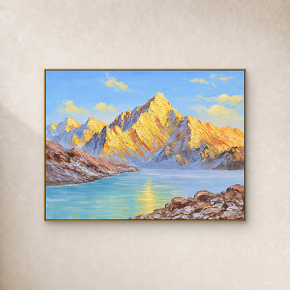 Golden mountain peaks above a turquoise lake, in a thin gold-tone floating frame on an ivory wall