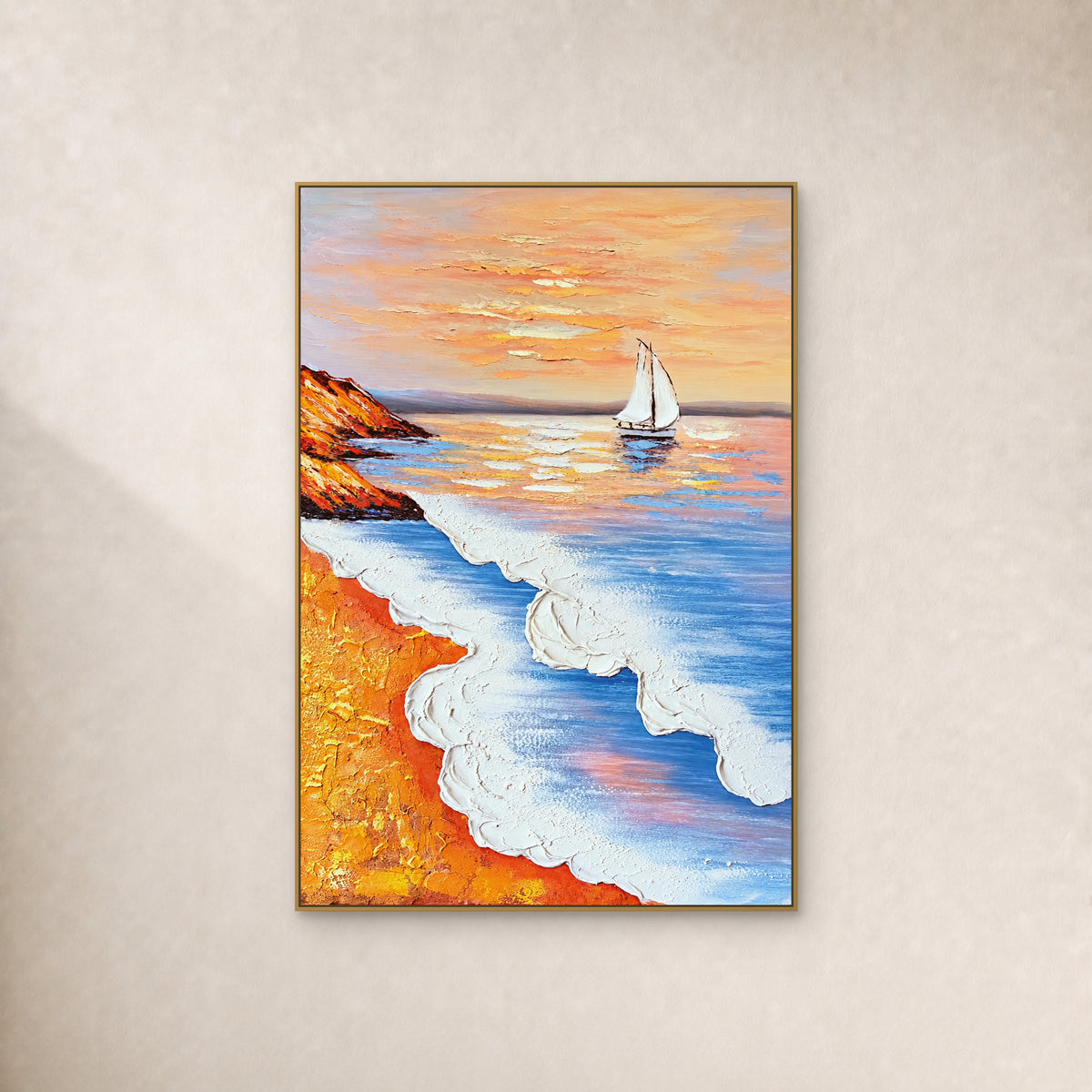 White sailboat, blue waves and ochre shore in a slim gold frame on an ivory wall.