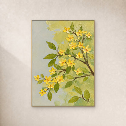 Yellow blossoms and olive leaves on branching brown stems, in a slim gold-tone frame against an ivory wall