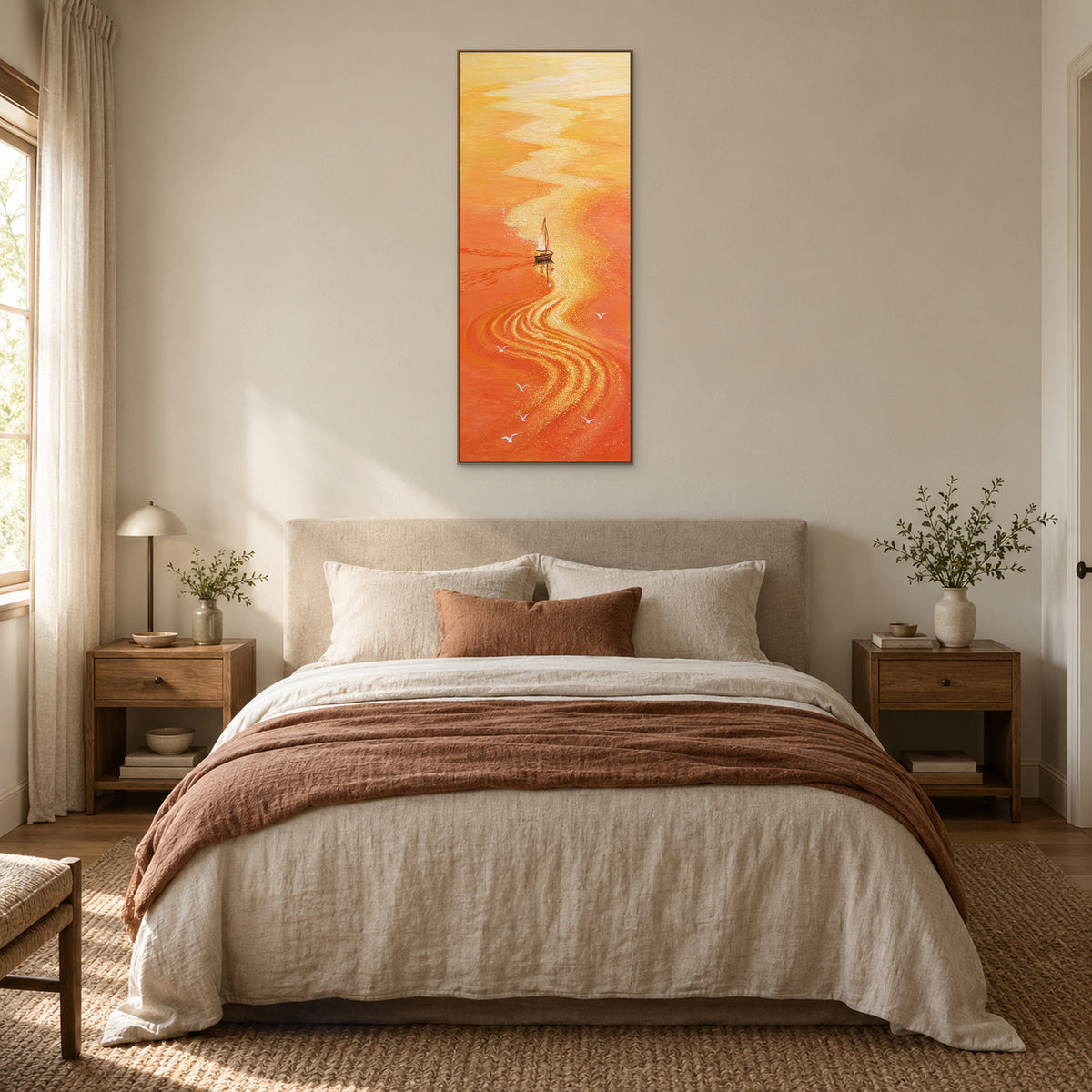 Orange sailboat painting in an oak-tone frame centred above a cream bed with a rust-coloured throw