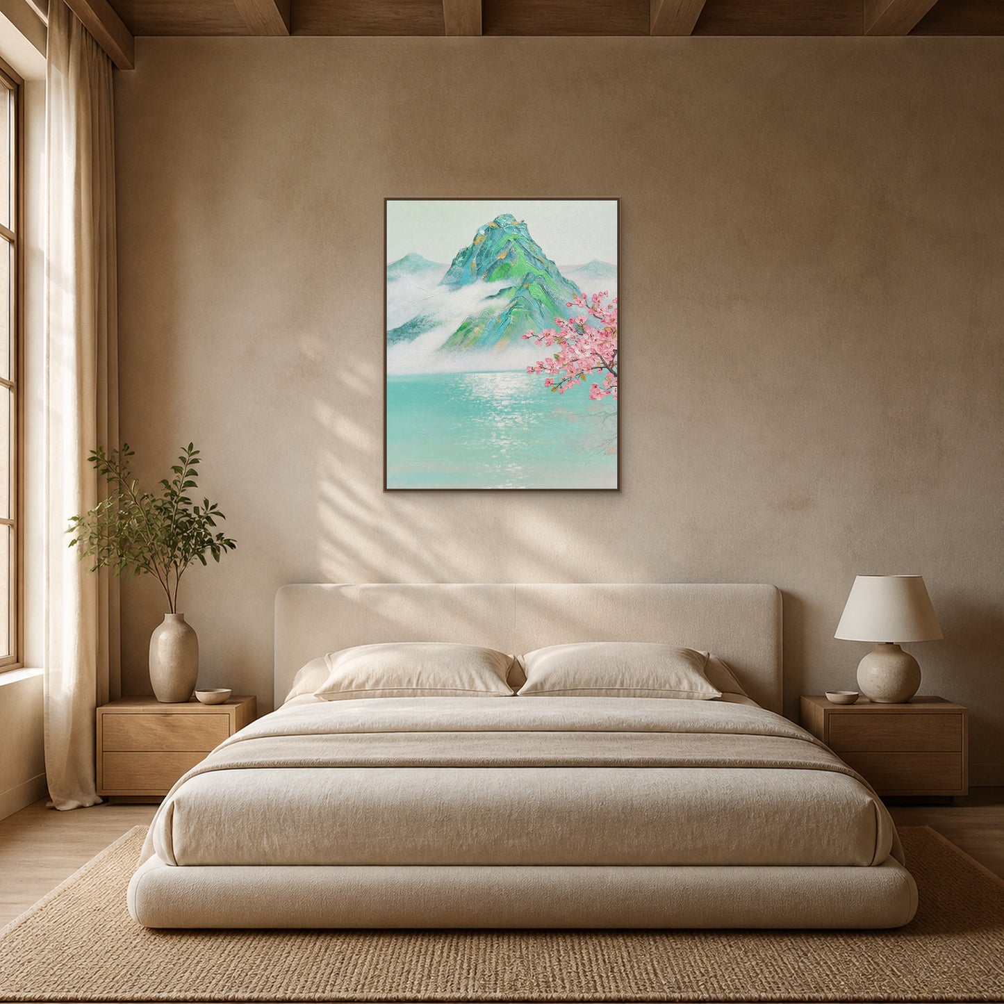 Misty mountain and peach blossom painting in a slim oak floating frame centred above a warm ivory bed
