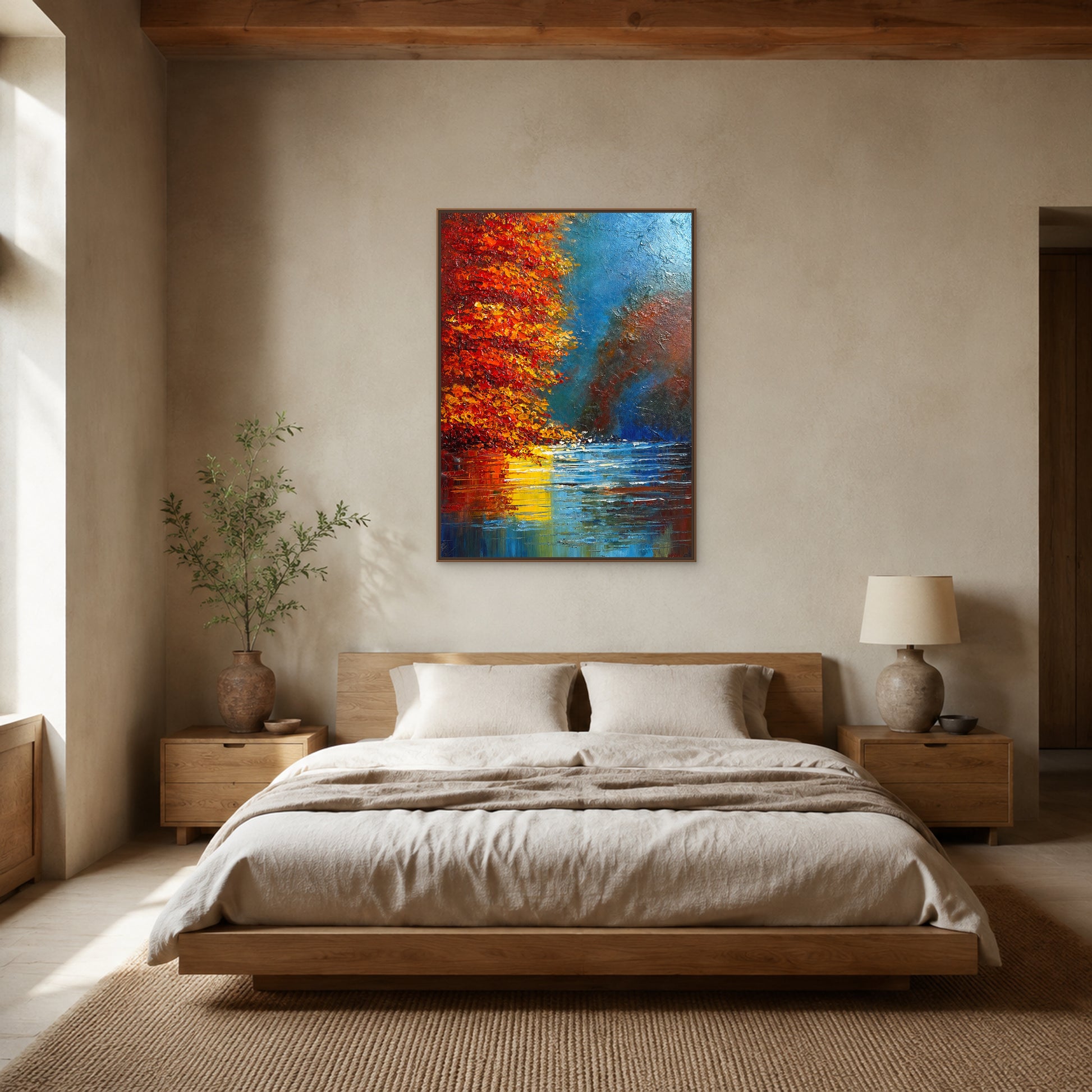 Vertical red autumn lake painting in a slim oak floating frame centred above an upholstered bed
