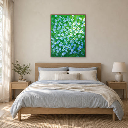 Blue flax floral painting above a bed in an oak floating frame with soft neutral bedding