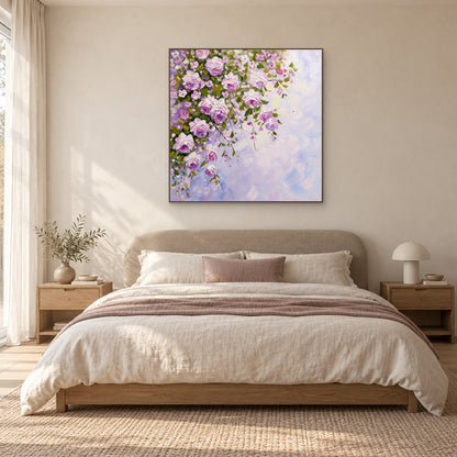 Lilac and pink rose painting in an oak-toned frame above a cream upholstered bed