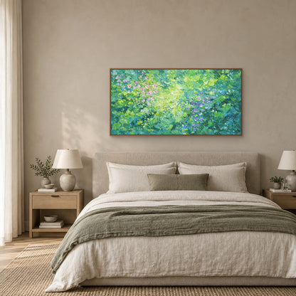 Green floral panorama in an oak-toned floating frame above an oatmeal upholstered headboard with cream bedding and a sage throw