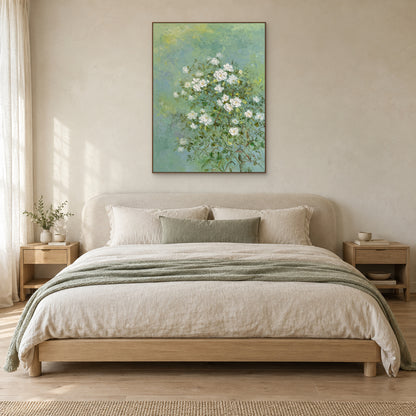Jasmine floral painting in an oak-tone floating frame centred above a linen bed