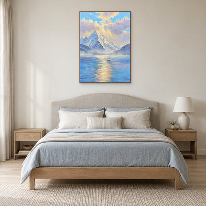 Blue and lavender mountain lake artwork in a slim oak-colour floating frame above a linen headboard