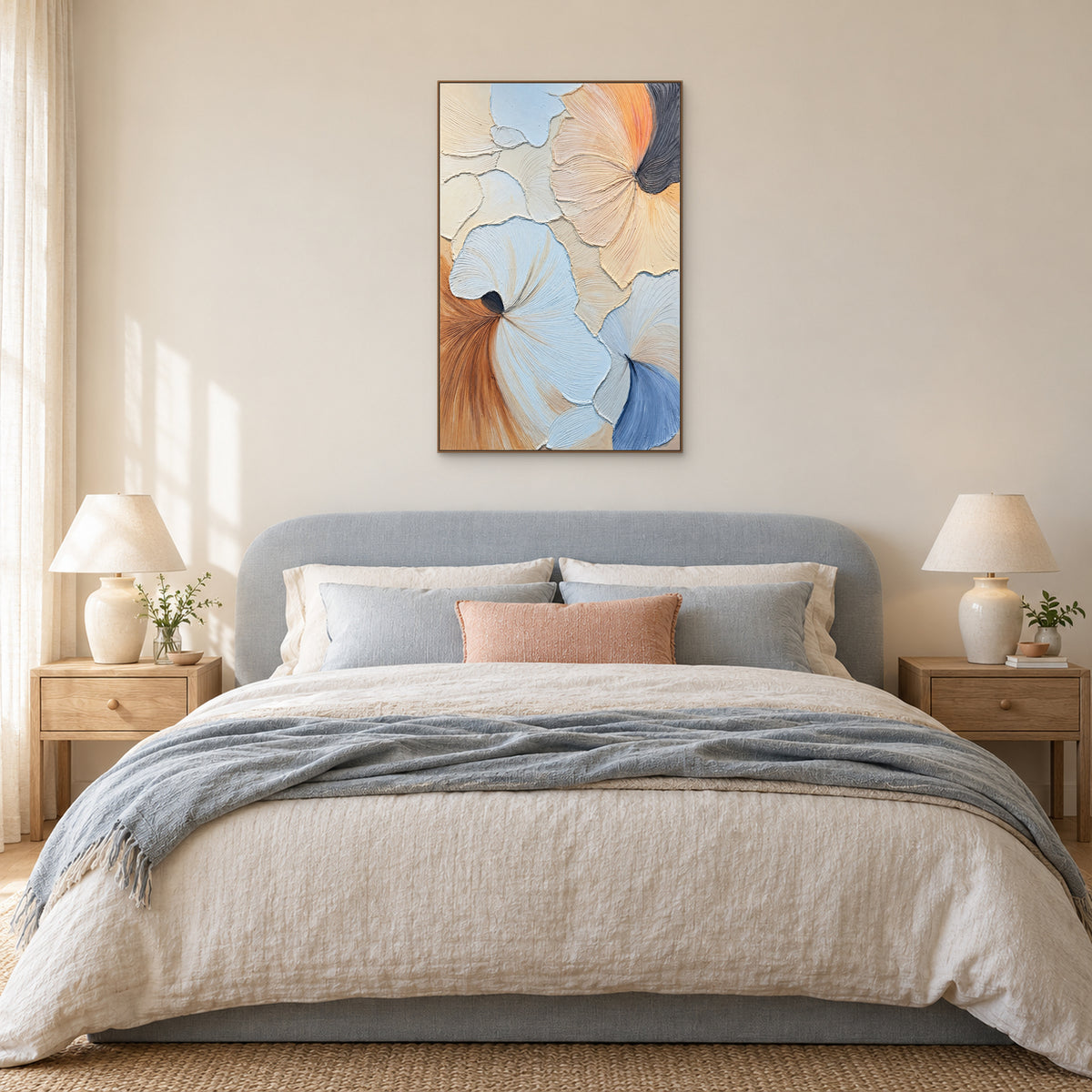 Blue and peach fan-shaped abstract in an oak-coloured frame above a pale-blue upholstered bed with a peach cushion