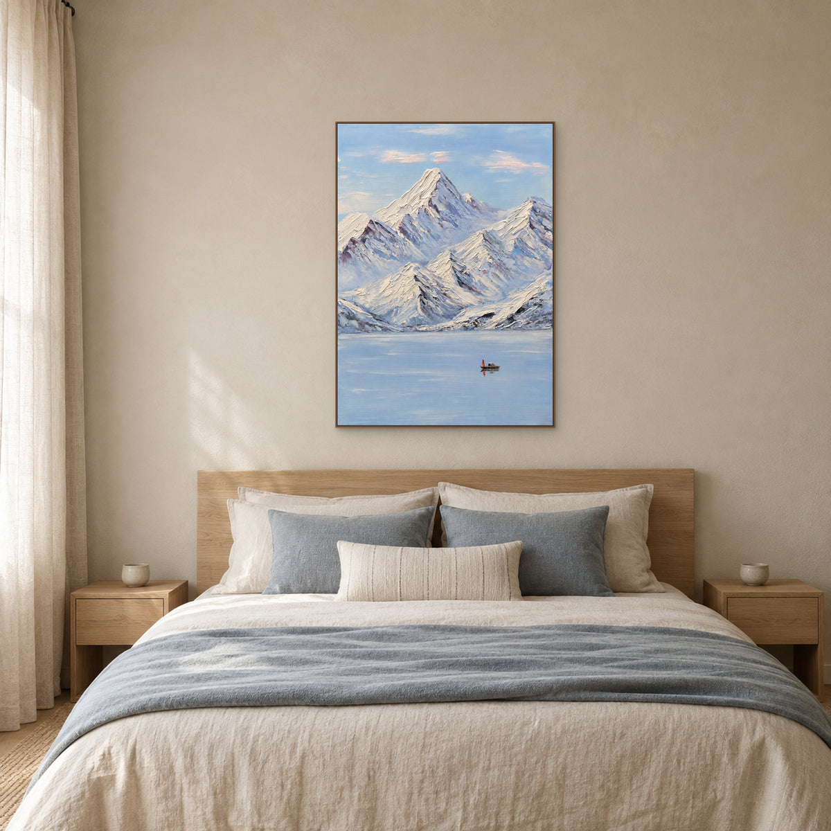 Snowy mountain and lake painting in an oak-tone floating frame centred above a linen bed