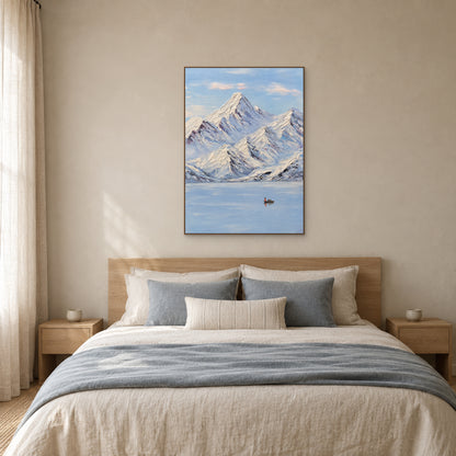 Snowy mountain and lake painting in an oak-tone floating frame centred above a linen bed