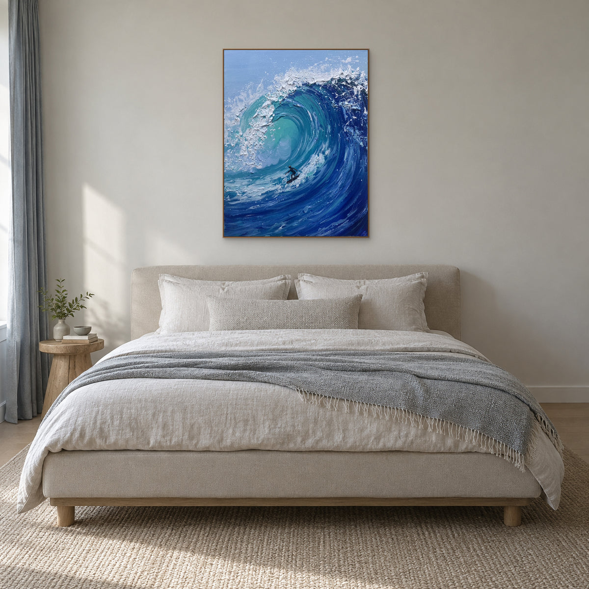 Oak-tone framed surfer and blue wave painting centred above a cream upholstered bed