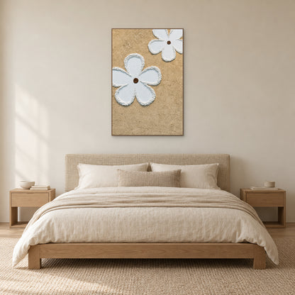 White floral relief in an oak-toned frame centred above a woven headboard and cream bedding