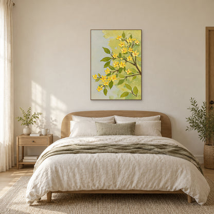 Oak-tone framed yellow blossom painting centred over a wooden headboard with cream bedding and an olive throw