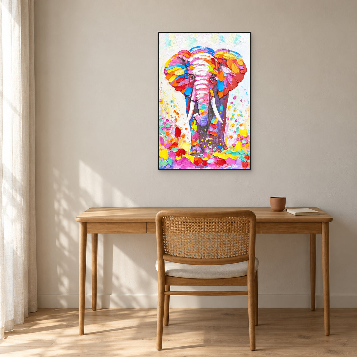 Elephant portrait in a black floating frame above an oak desk with a cane-back chair