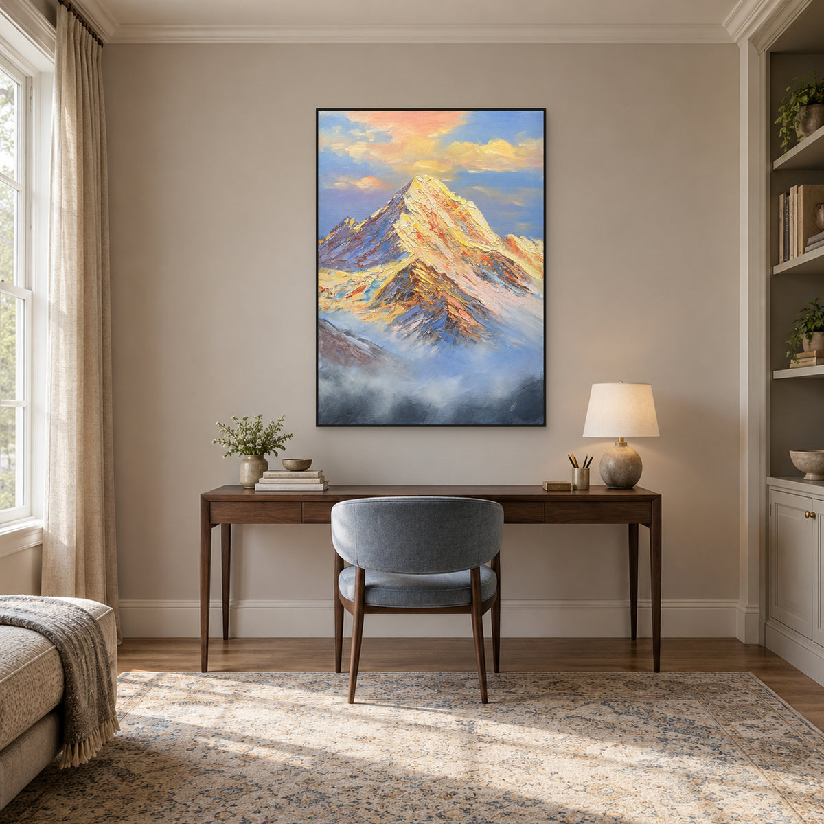 Textured snow-peak painting in a black floating frame above a wooden desk