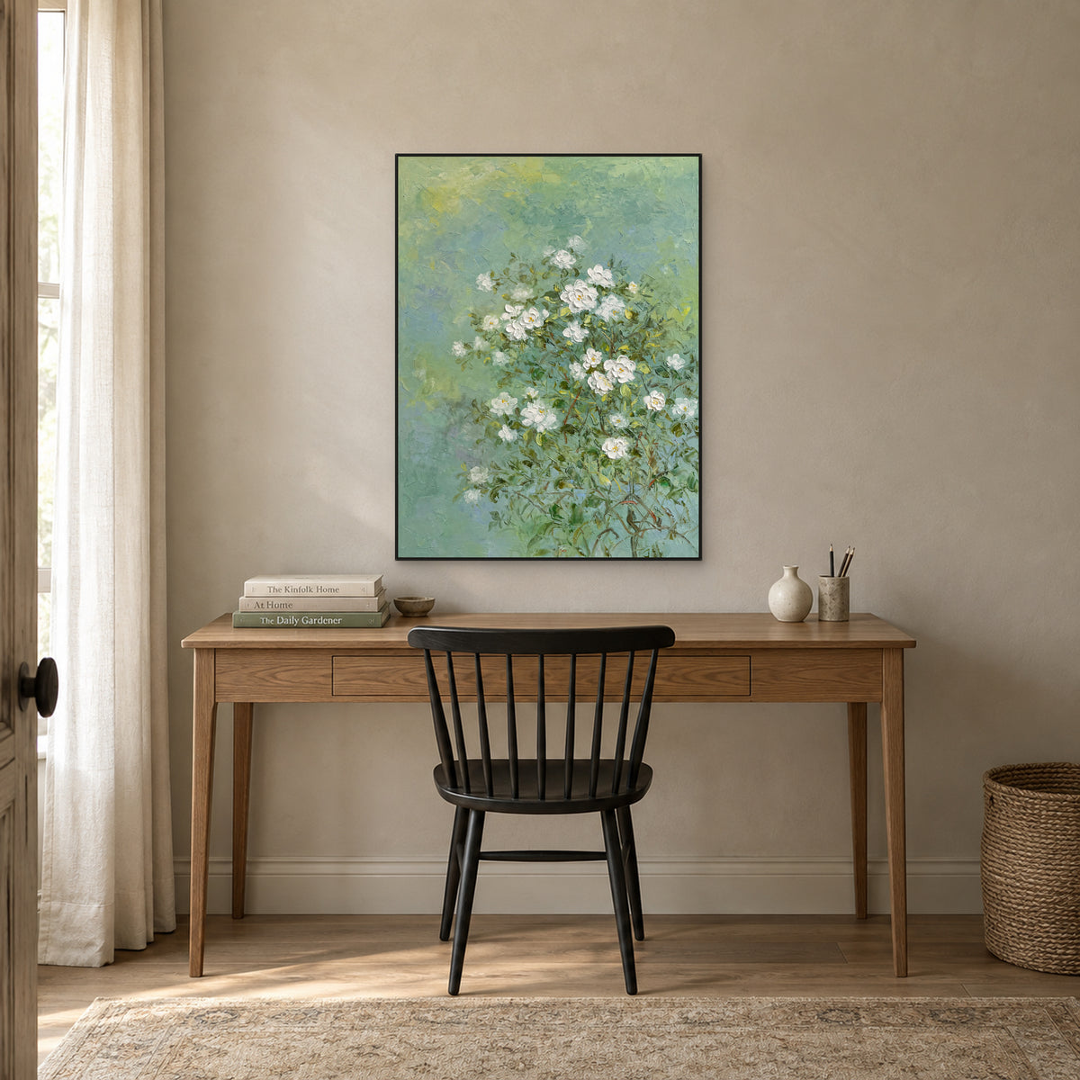 White jasmine and green botanical painting in a black floating frame above a wooden writing desk