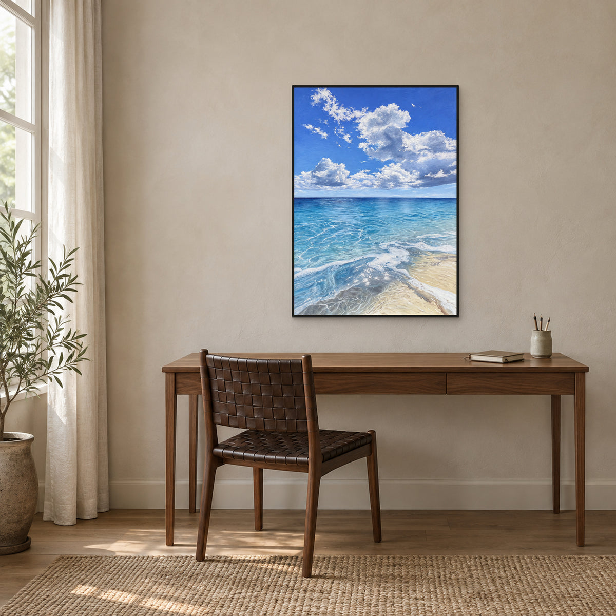 Ocean and cloud painting in a black floating frame above a walnut desk beside a window