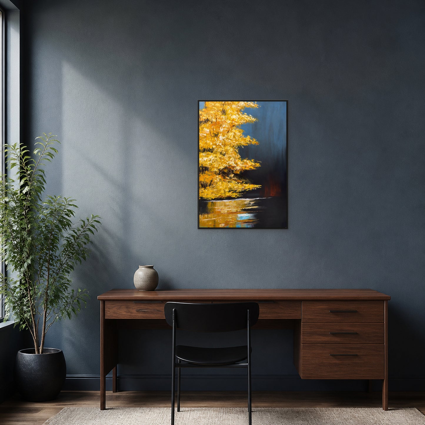 Golden Maple at Dusk in a slim black floating frame centred above a walnut desk on a charcoal-blue wall