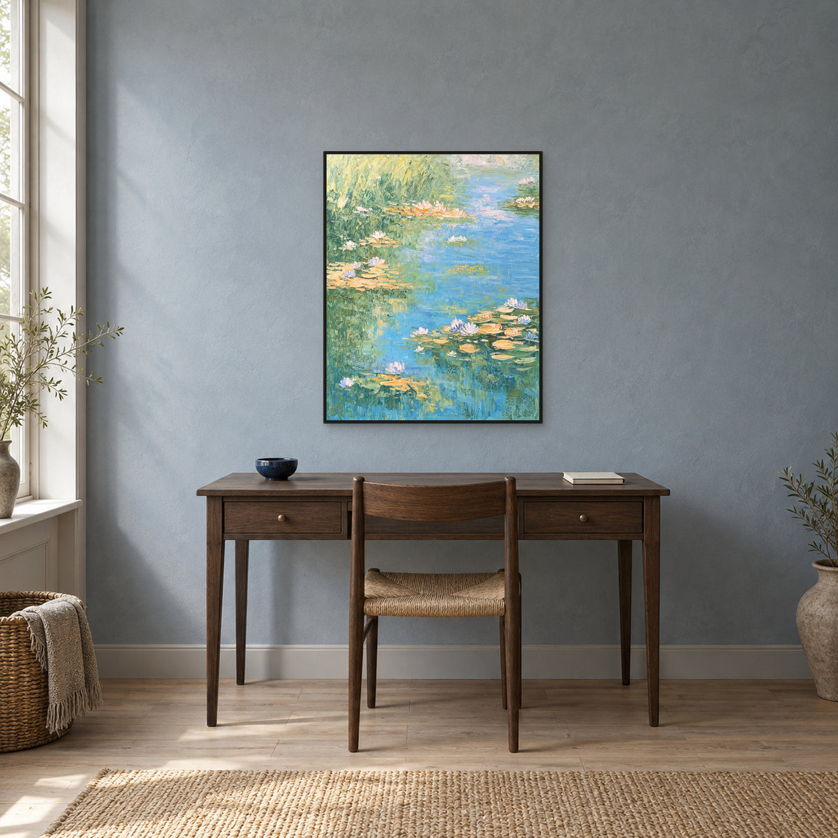 Water-lily artwork in a slim black floating frame above a smoked-oak writing desk