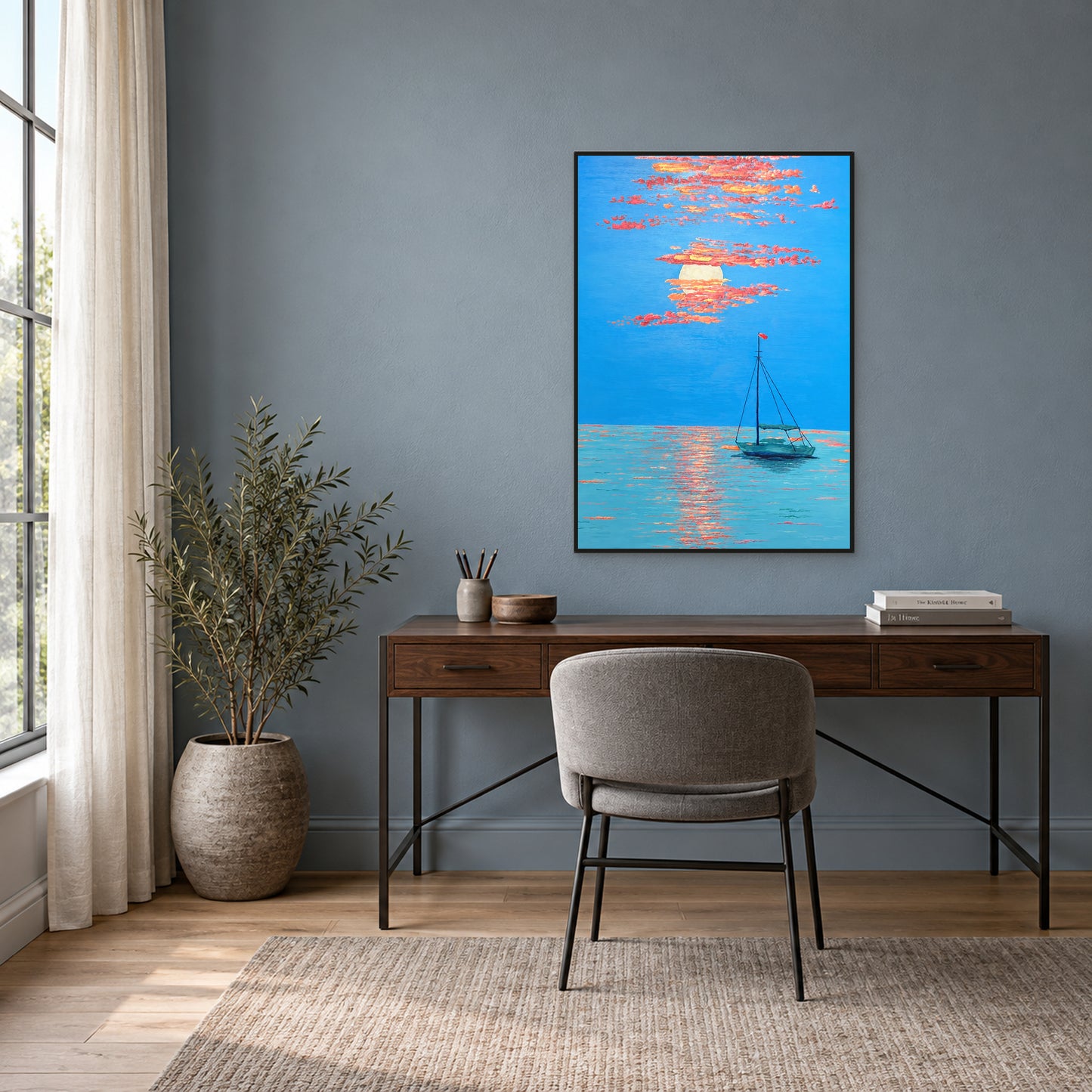 Coral sunset and teal boat painting in a thin black floating frame above a walnut desk against a blue-grey wall.