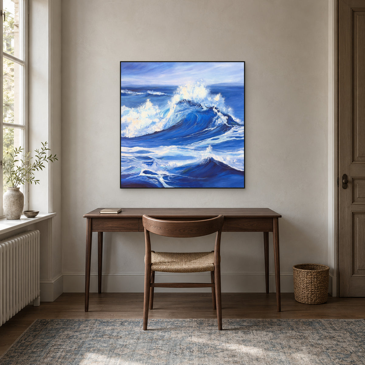 Periwinkle wave painting with a black floating frame centred above a walnut desk