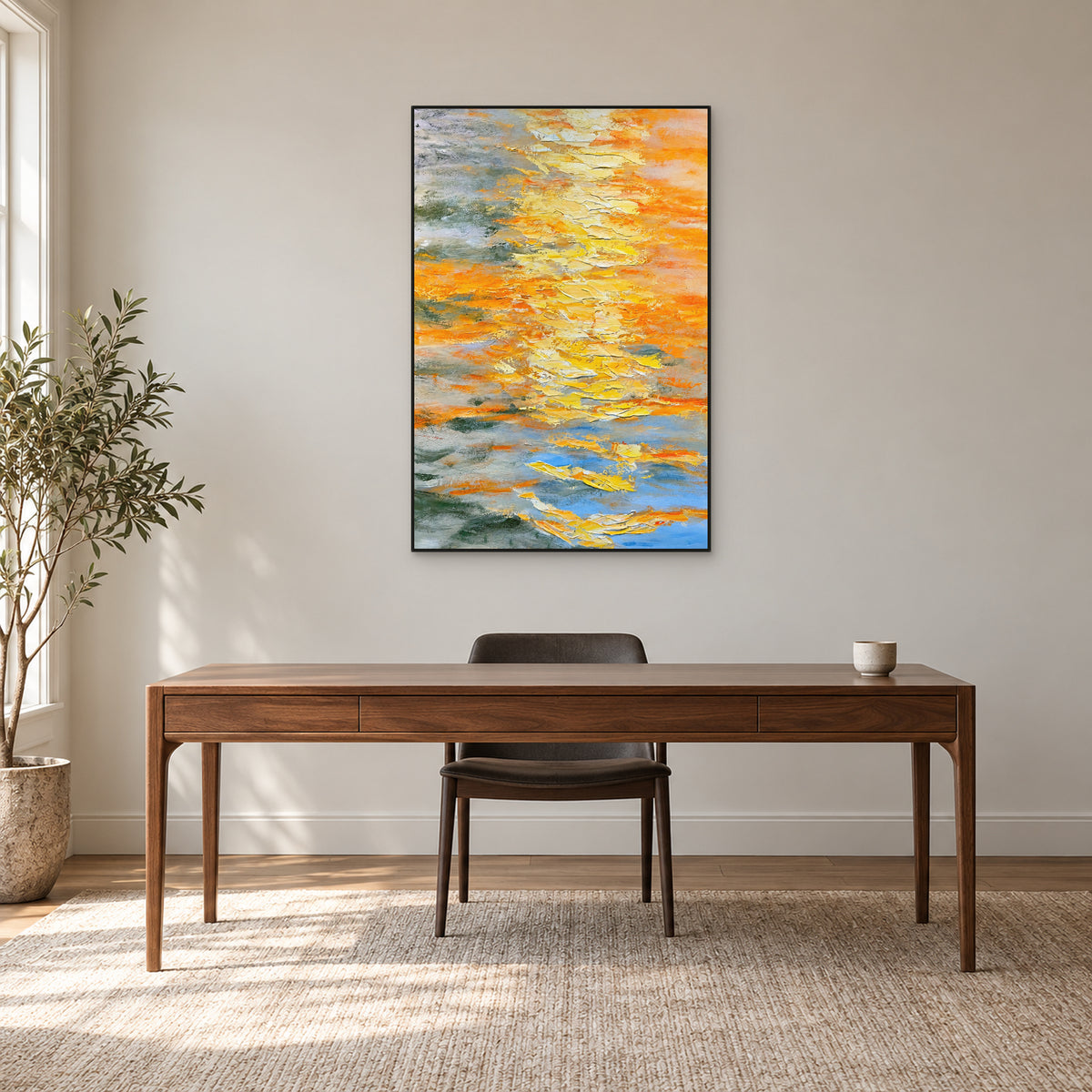 Yellow and blue-grey textured abstract in a thin black frame above a walnut desk against a light greige wall