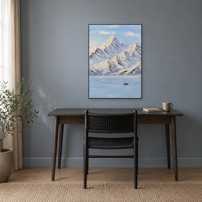Blue and white mountain landscape in a black floating frame above a wooden desk on a blue-grey wall