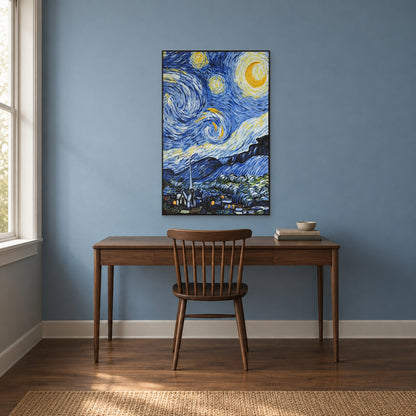 Crescent moon and swirling blue sky in a black frame above a walnut desk against a muted blue study wall.