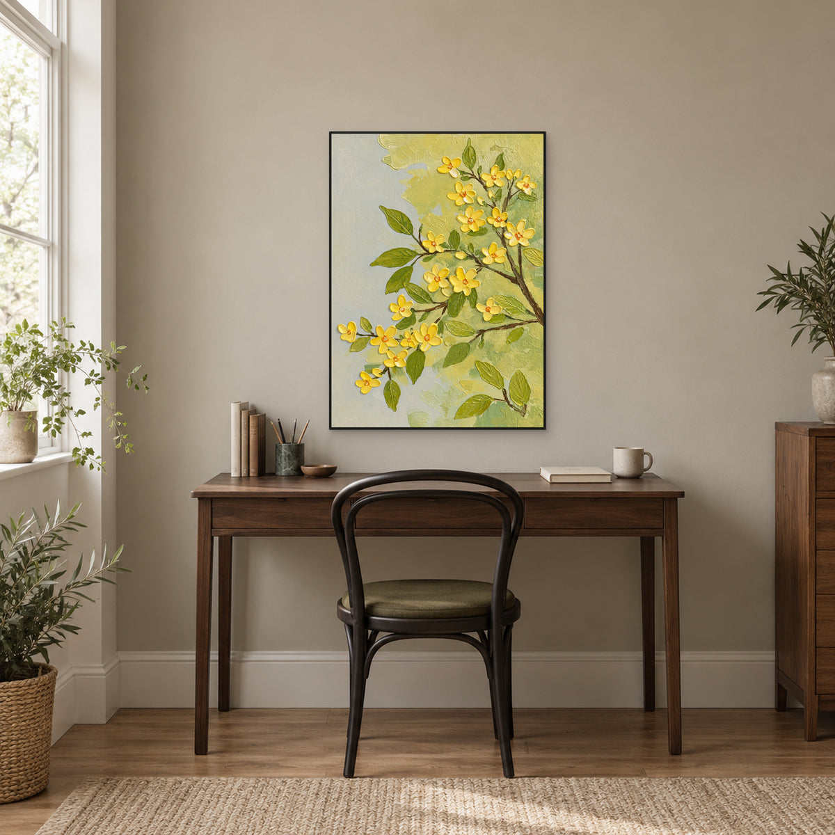Black-framed yellow flower painting above a dark wood desk beside a bright window
