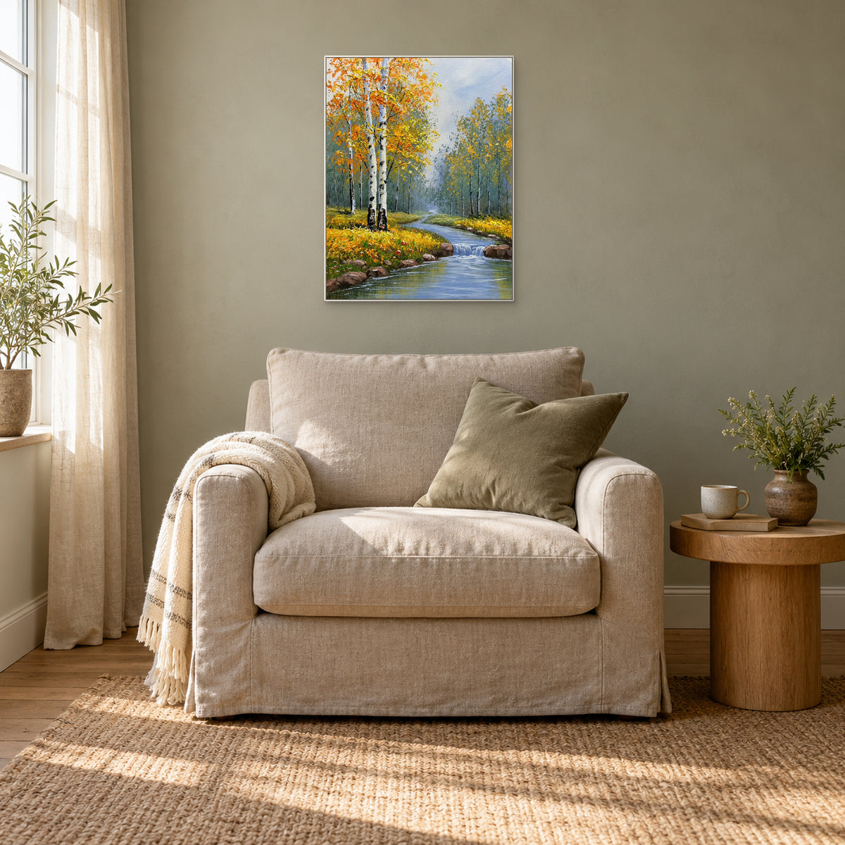 Golden birch foliage and a misty blue stream, framed in white above a flax-coloured reading chair.