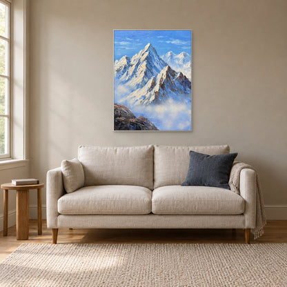Vertical mountain artwork in a white frame above a cream sofa in a reading room