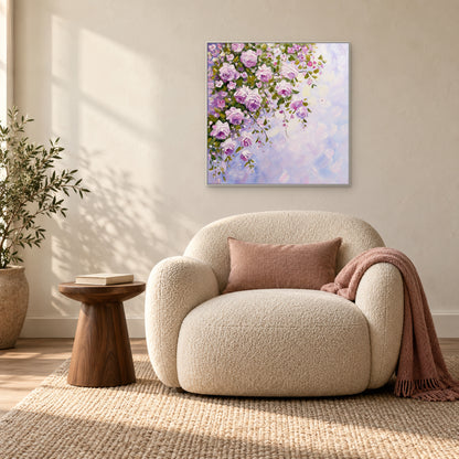 White-framed cascading rose painting above a cream armchair beside a window