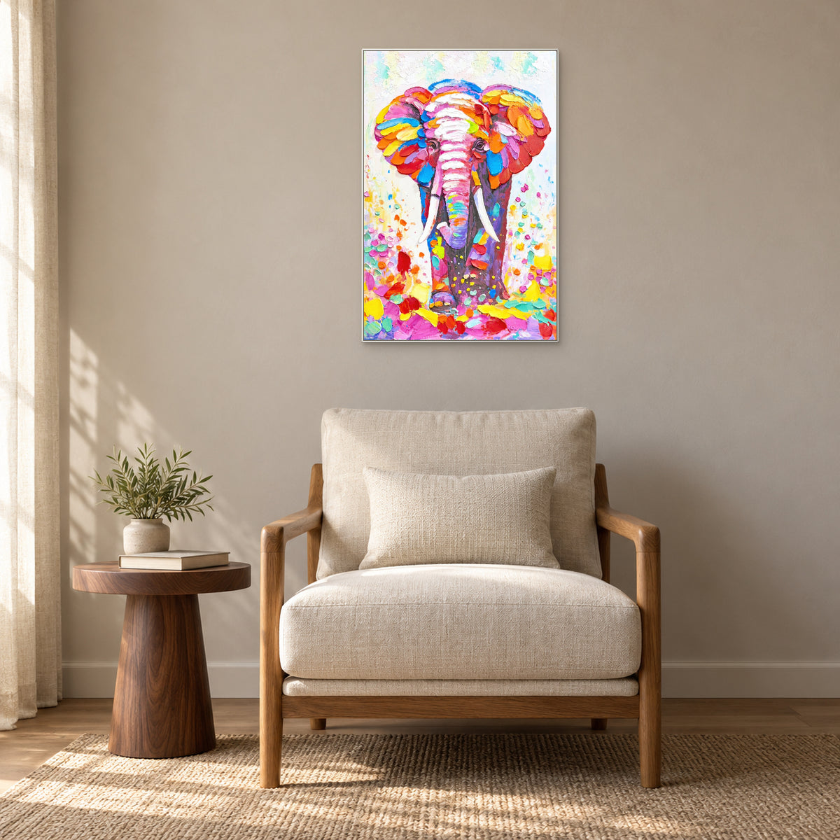 Elephant painting in a white frame above a cream armchair beside a round wooden side table