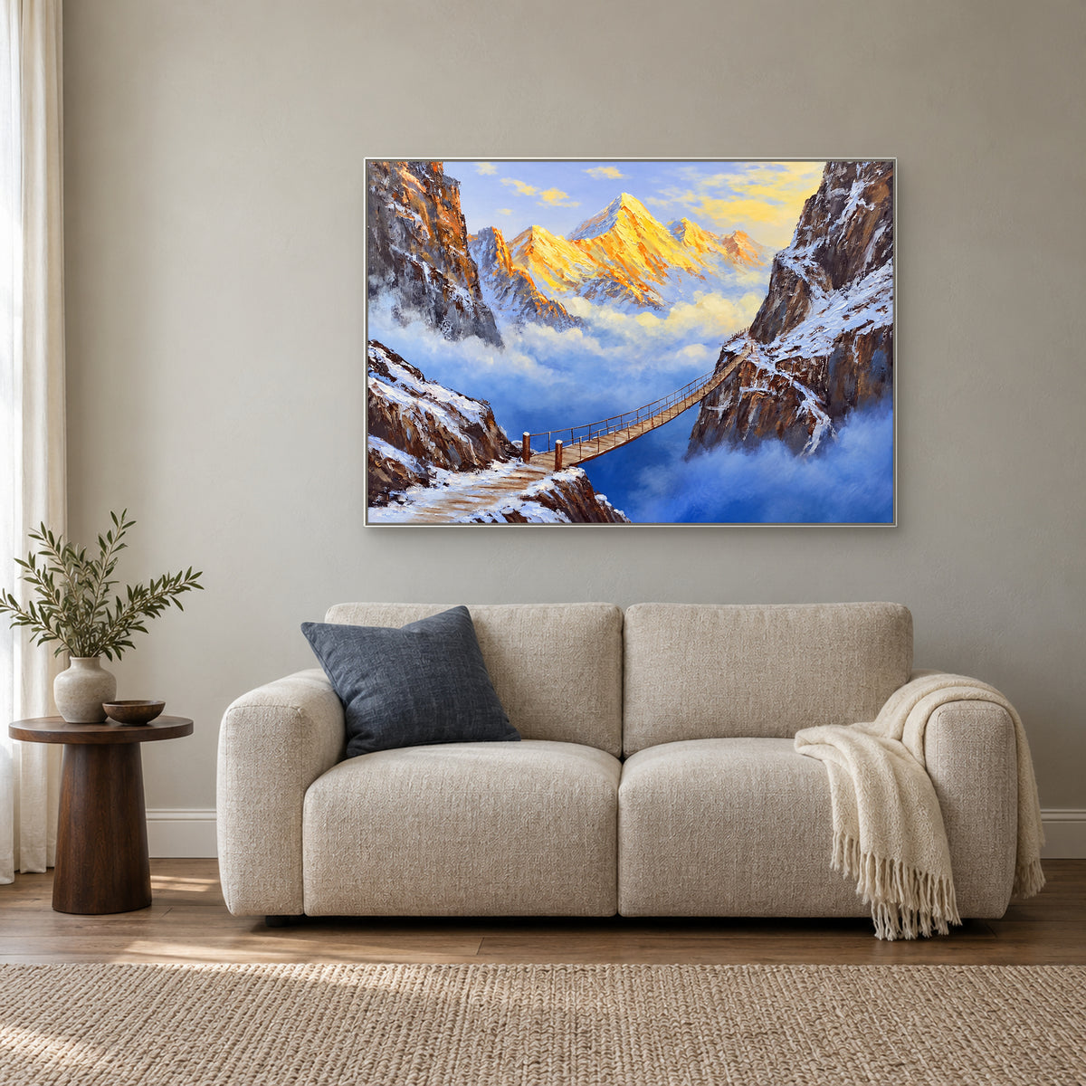 Suspension bridge landscape in a white frame above an oatmeal settee in a reading corner