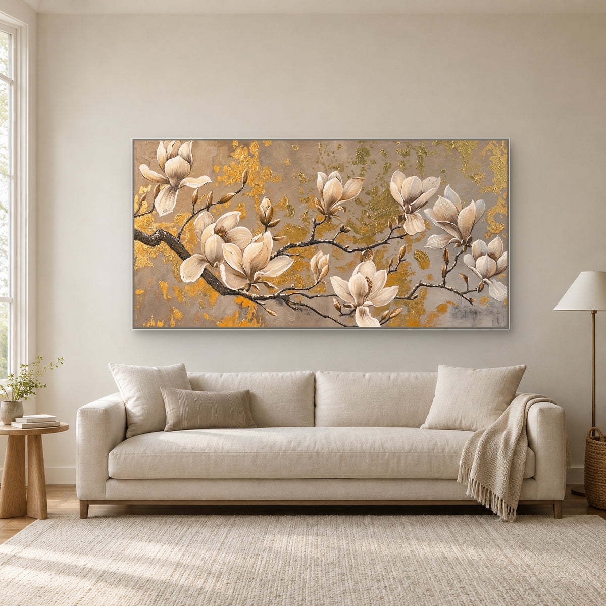 White-framed magnolia floral painting above a cream settee beside a sunlit window