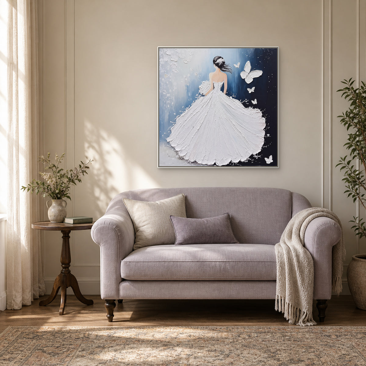 Woman and butterfly painting in a slim white frame above a curved settee in a softly lit reading nook