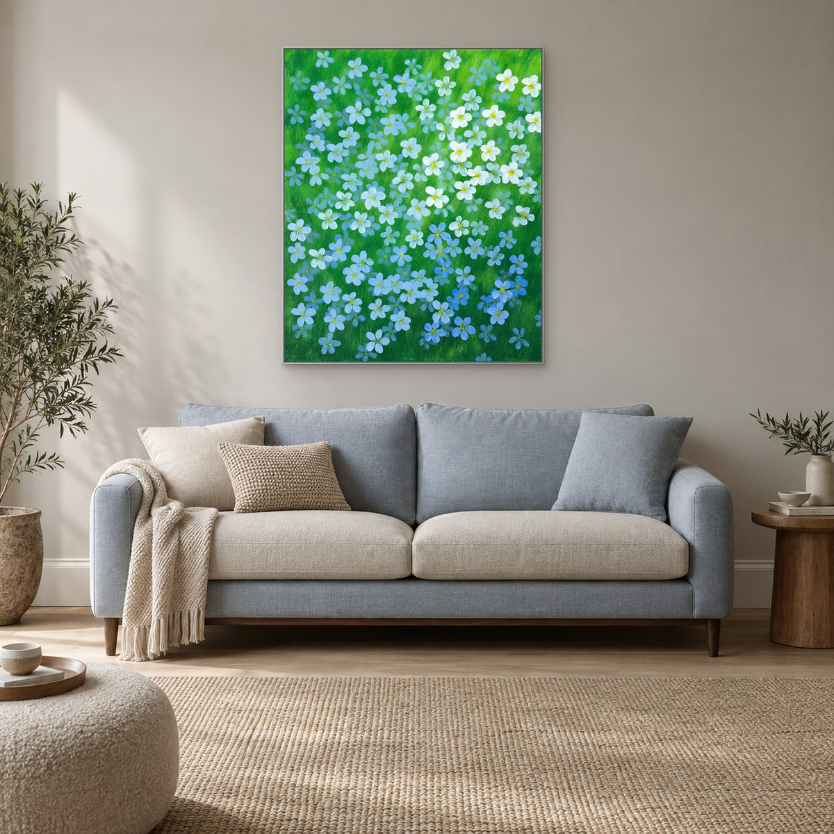Blue flax floral artwork in a silver floating frame in a bright modern living room