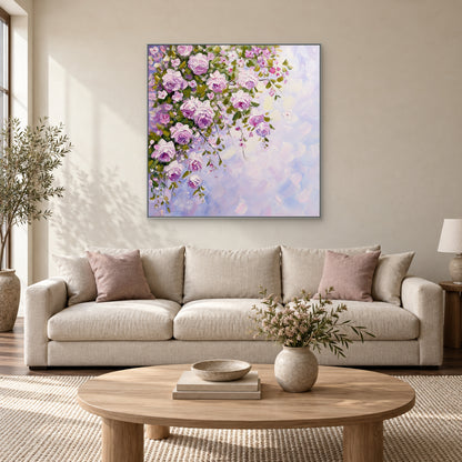 Lilac rose canvas in a silver-toned frame above a cream sofa with dusty-pink cushions
